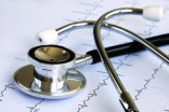 A stethoscope on the top of the EKG chart A stethoscope on the top of the EKG chart