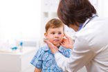 Doctor examining child Senior female doctor examining little child boy.