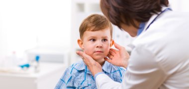 Doctor examining child Senior female doctor examining little child boy.