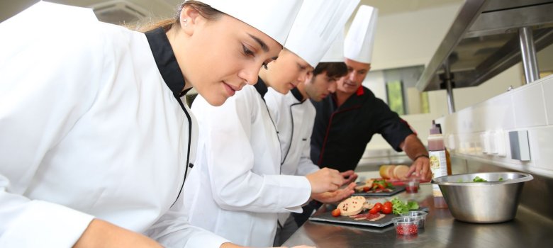 Team of young chefs preparing delicatessen dishes Team of young chefs preparing delicatessen dishes