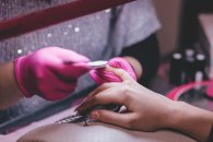 53_2_Manikuere_Hygiene Eine Hand bekommt die Nägel gefeilt
