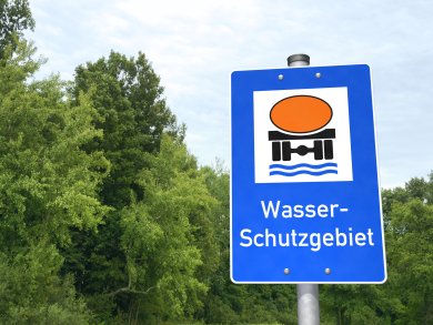 Schild Trinkwasserschutzgebiet Aufgestelltes Schild Trinkwasserschutzgebiet, im Hintergrund des Bildes sind Bäume erkennbar.