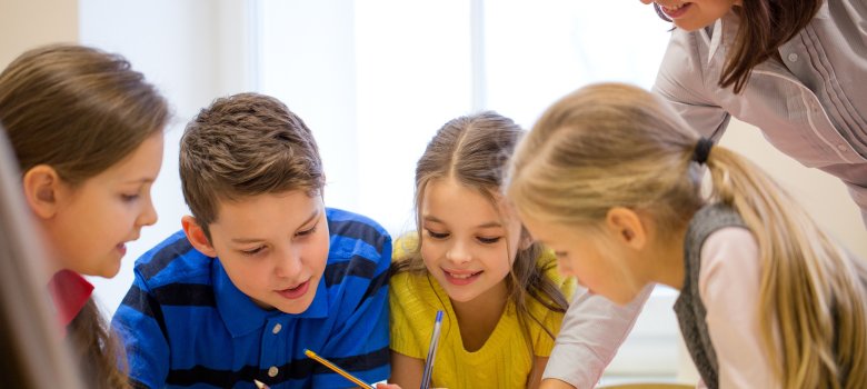group of school kids writing test in classroom group of school kids writing test in classroom